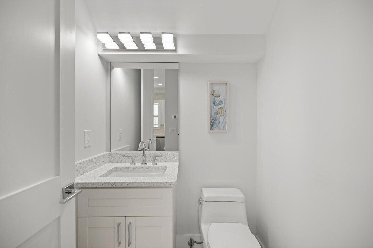 171 Redbud Ln Inlet Beach Inlet Beach, FL 32461 - Photo 11 of 38 a bathroom with a toilet a sink and mirror