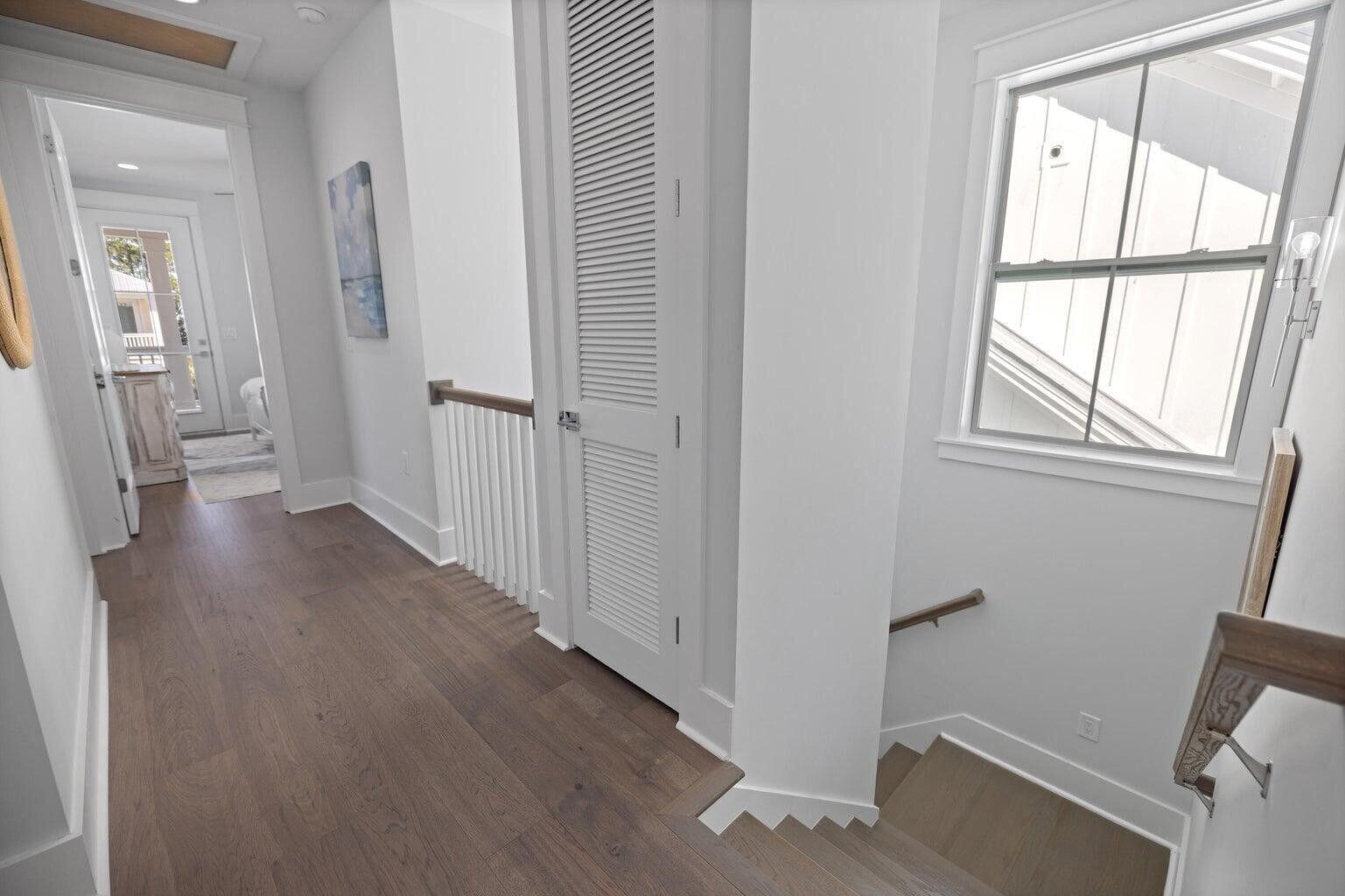 171 Redbud Ln Inlet Beach Inlet Beach, FL 32461 - Photo 23 of 38 a view of a hallway with wooden floor and cabinet