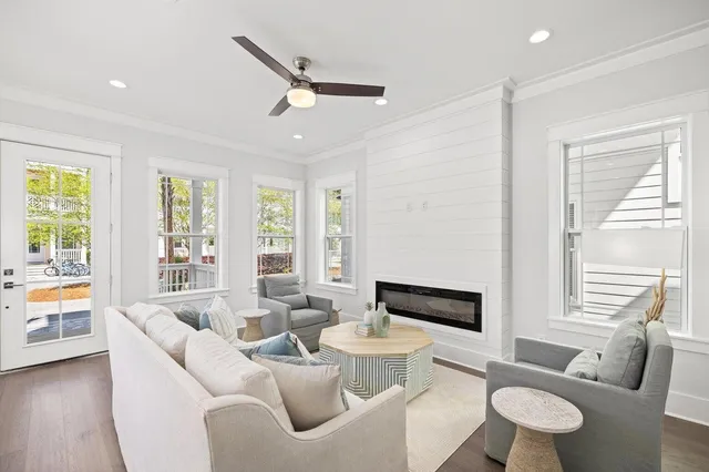 a large white kitchen with stainless steel appliances kitchen island granite countertop a stove a sink and a refrigerator