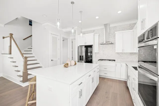a large kitchen with a table and chairs