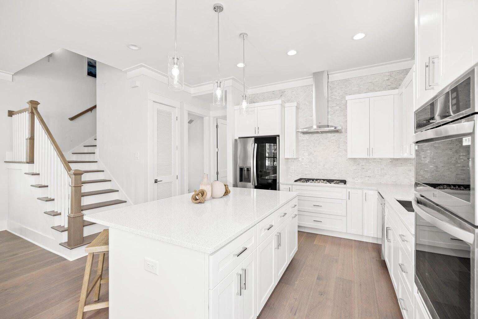 171 Redbud Ln Inlet Beach Inlet Beach, FL 32461 - Photo 6 of 38 a large white kitchen with stainless steel appliances kitchen island granite countertop a stove a sink and a refrigerator