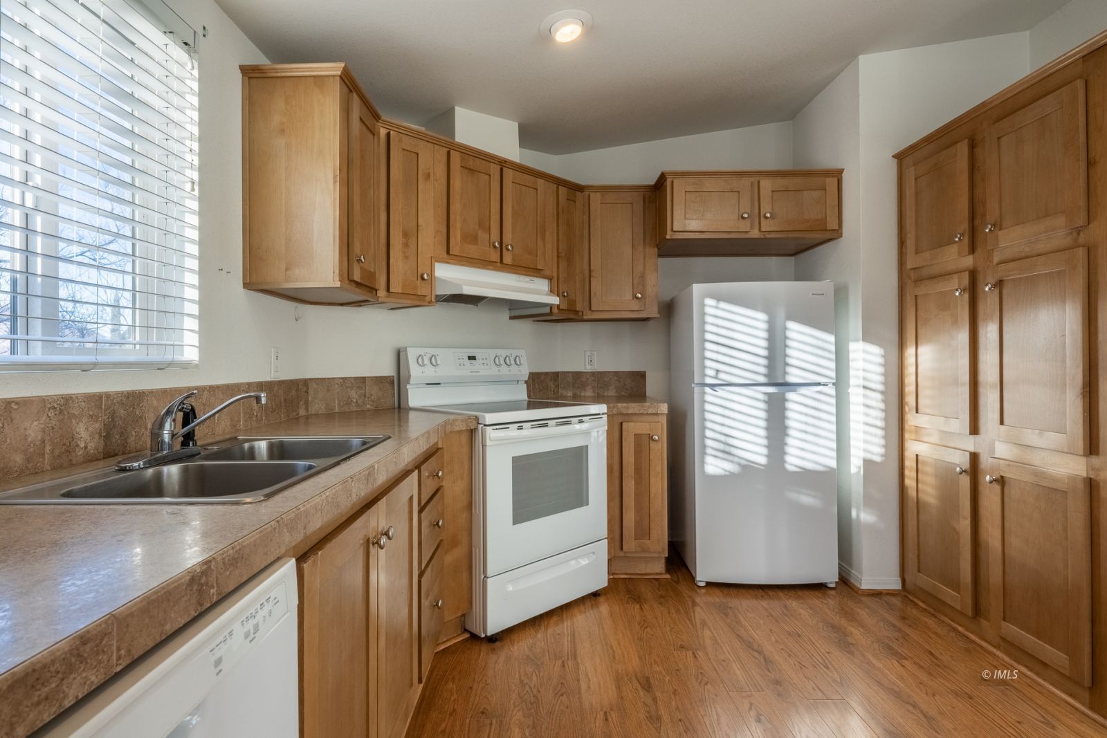231 West Street Big Pine, CA 93513 - Photo 6 of 23 a kitchen with stainless steel appliances granite countertop a sink and a refrigerator