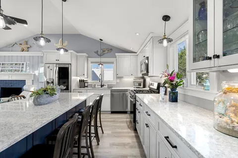a kitchen with sink cabinets and wooden floor