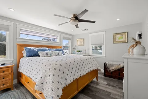 a bedroom with a bed and wooden floor