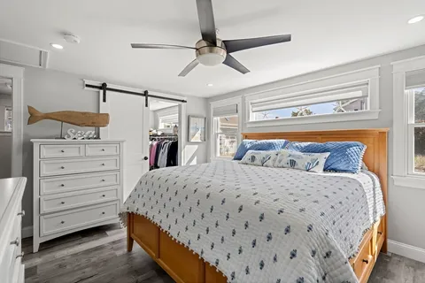 a bedroom with a large bed and a chandelier