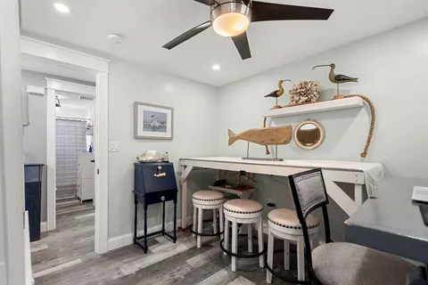 a view of a dining room with furniture and chandelier