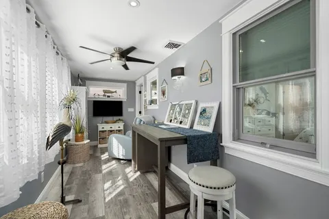 a view of a livingroom with furniture window and wooden floor