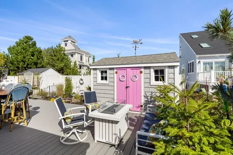 a front view of a house with outdoor seating