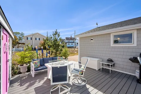 a view of a patio with table and chairs and potted plants