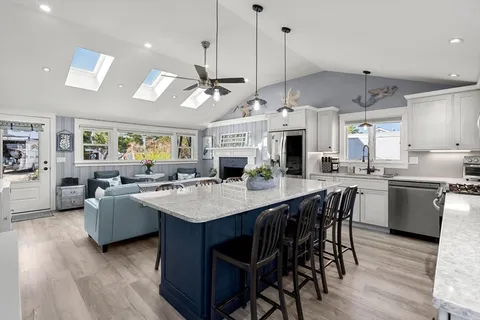 a large kitchen with a table and chairs