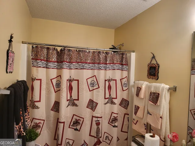 a bathroom with a shower and a sink