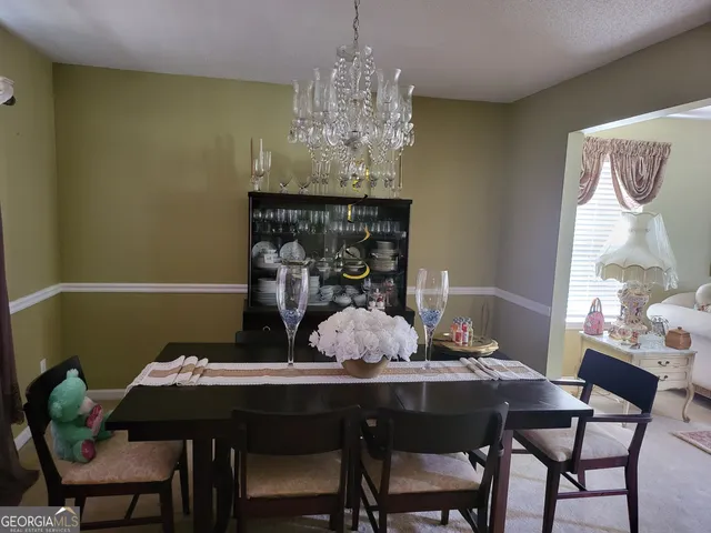 a green field with lots of trees in the background