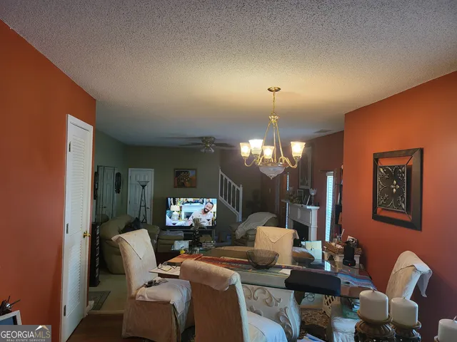 a living room with furniture a lamp and a chandelier