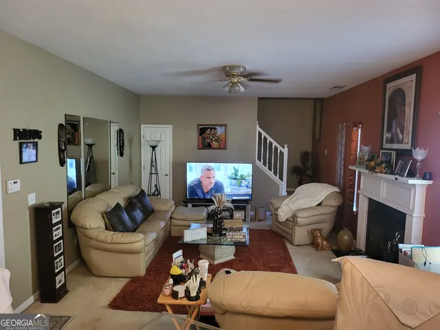 a living room with furniture and a flat screen tv