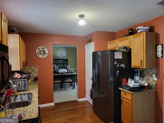 a kitchen with a refrigerator and a sink