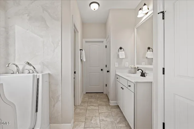 a bathroom with a double vanity sink and mirror