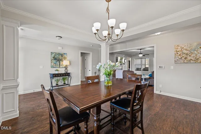 a view of a dining room with furniture a chandelier and wooden floor
