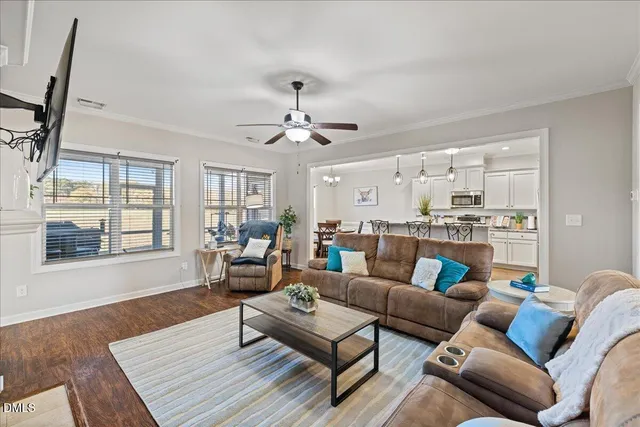 a living room with furniture and a wooden floor