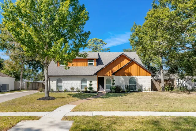 a front view of house with yard and trees