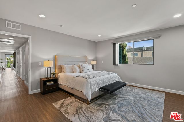 a bedroom with a bed and a night stand