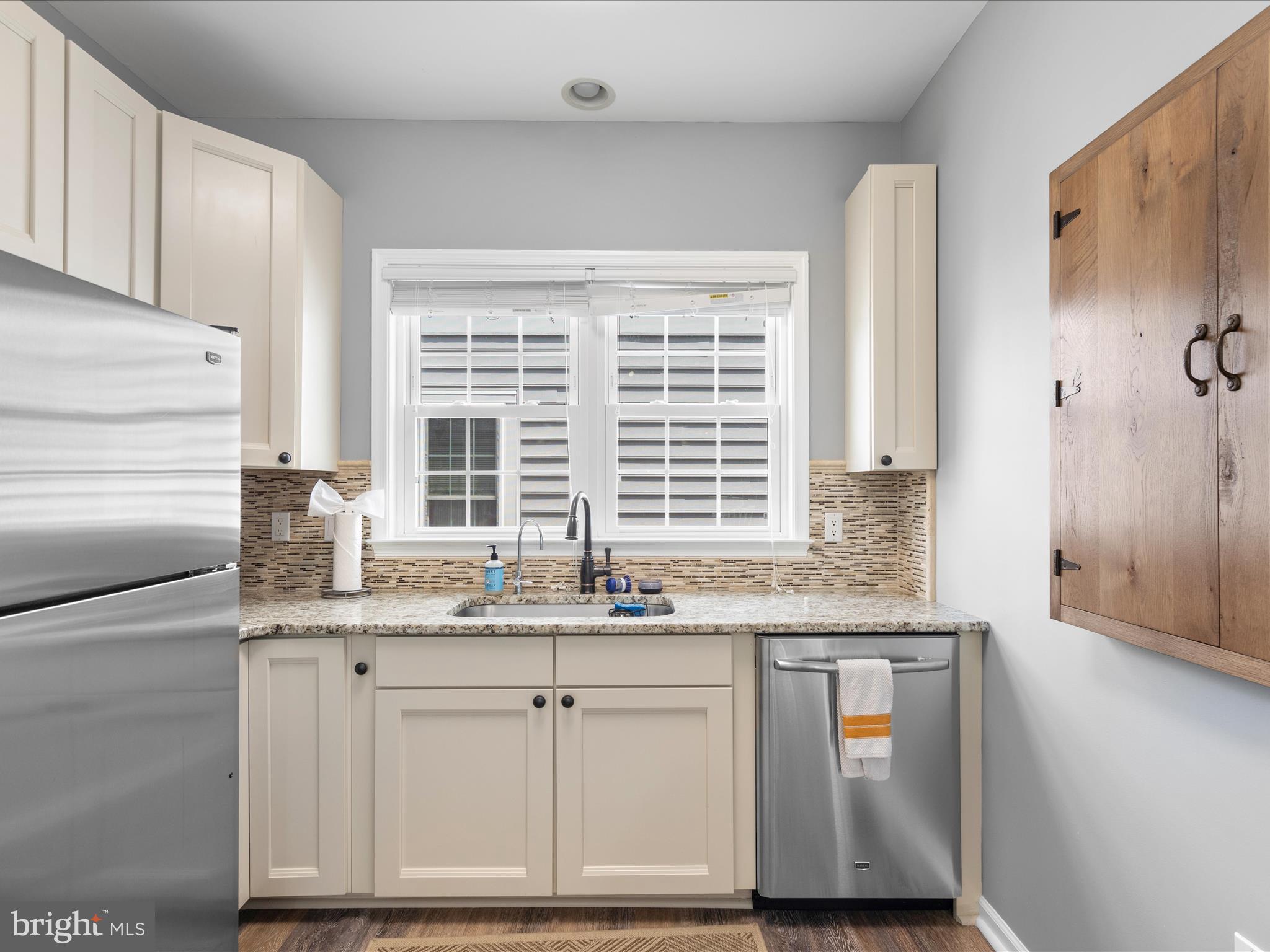 9739 Golf Course Road, Unit D102 Ocean City, MD 21842 - Photo 14 of 42 a kitchen with granite countertop cabinets and window