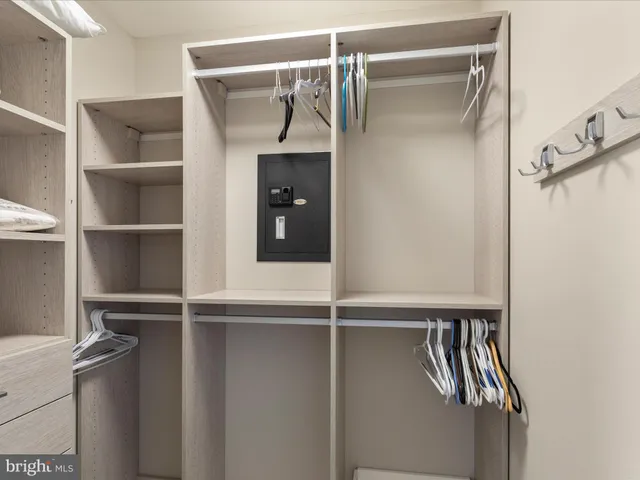 a view of walk in closet with empty racks