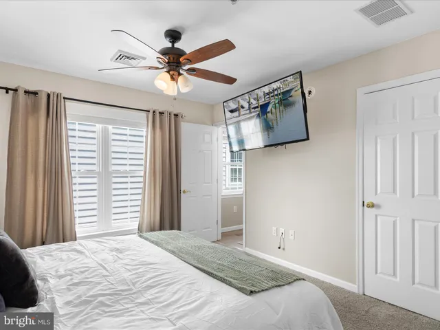 a bedroom with a large bed and a window