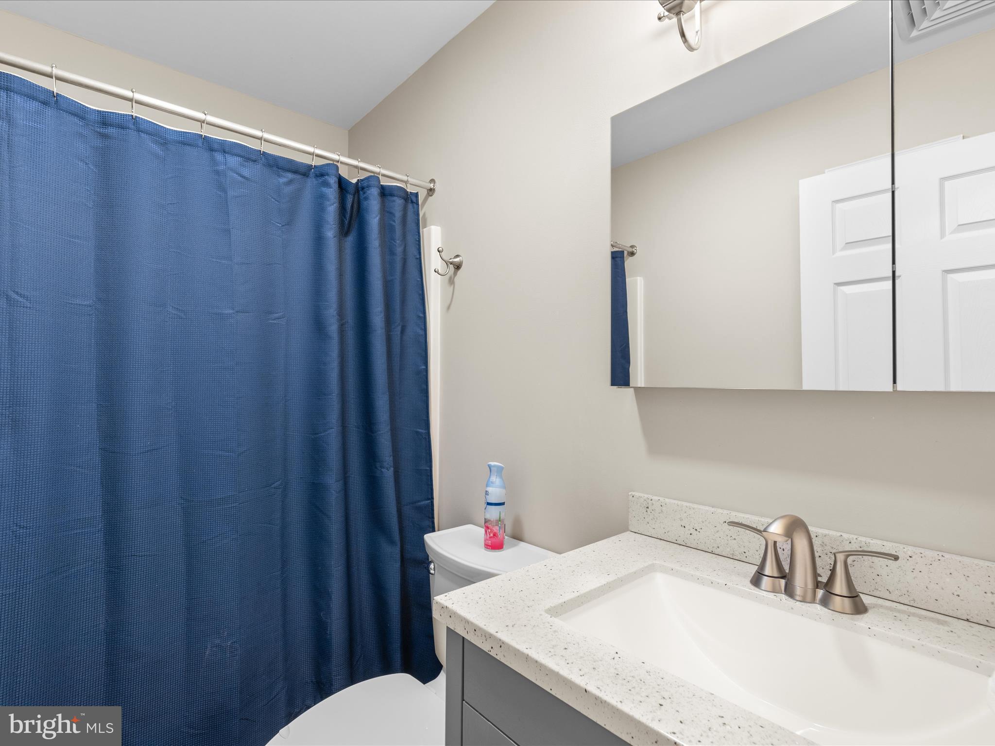 9739 Golf Course Road, Unit D102 Ocean City, MD 21842 - Photo 29 of 42 a bathroom with a sink vanity mirror and toilet