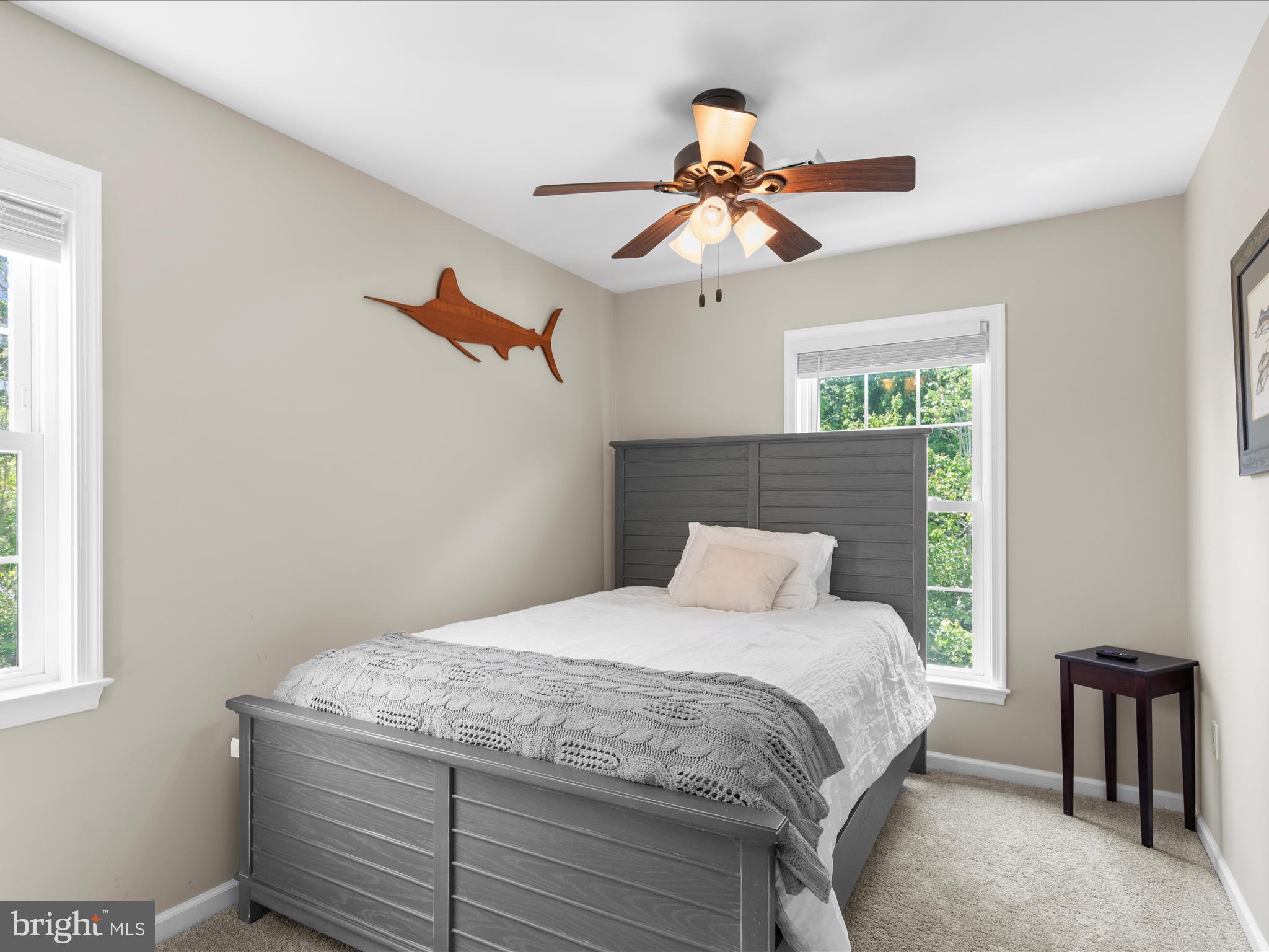 9739 Golf Course Road, Unit D102 Ocean City, MD 21842 - Photo 31 of 42 a bedroom with a bed and a chandelier