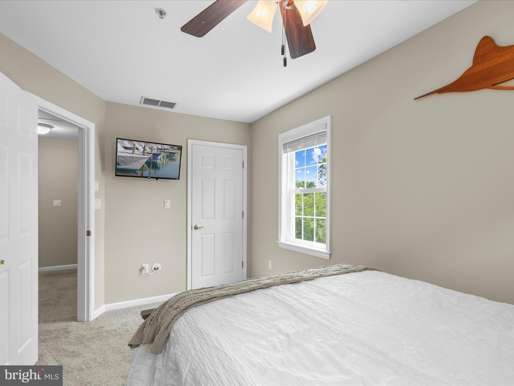 9739 Golf Course Road, Unit D102 Ocean City, MD 21842 - Photo 33 of 42 a bedroom with a bed and a window