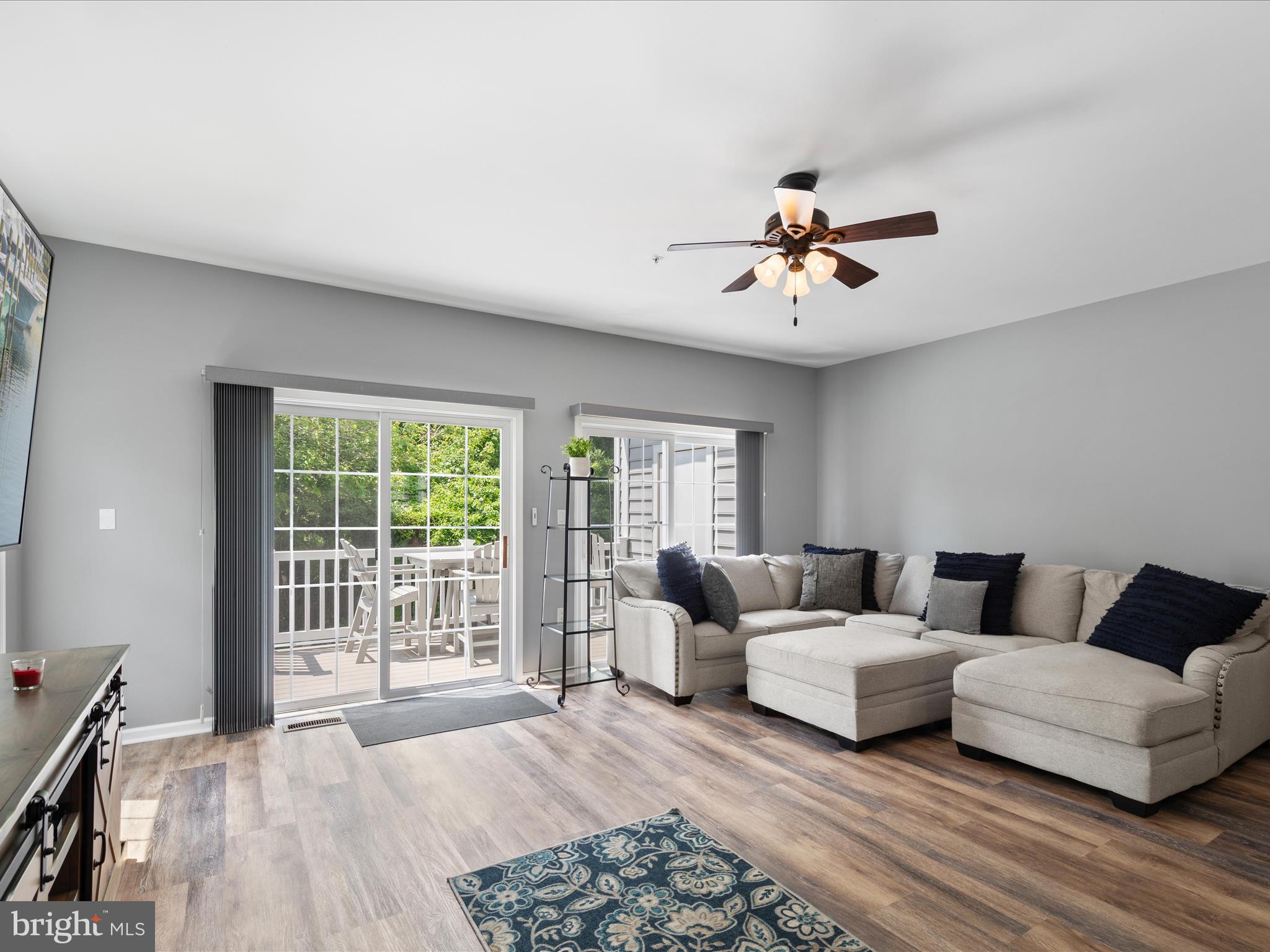 9739 Golf Course Road, Unit D102 Ocean City, MD 21842 - Photo 7 of 42 a living room with furniture and a chandelier