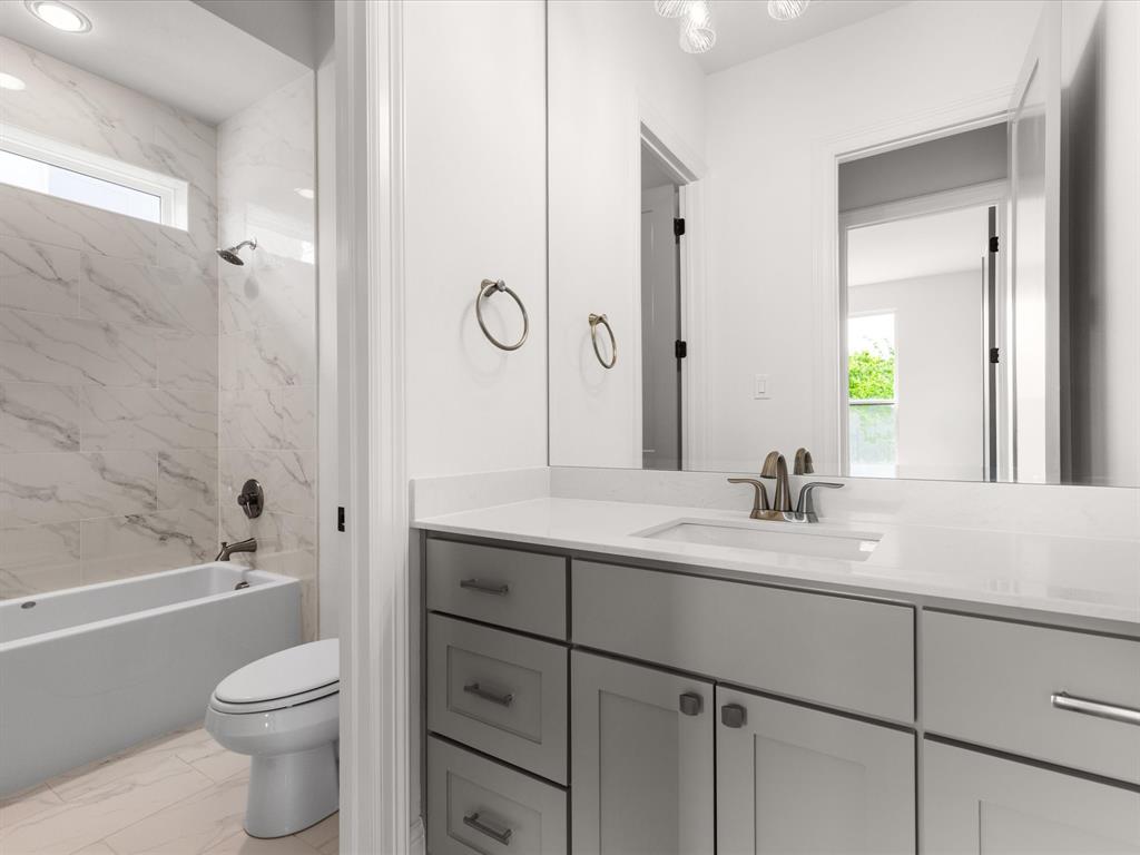 7104 Prairie Ridge Road Argyle, TX 76226 - Photo 21 of 39 Full bathroom featuring vanity, shower / tub combination, and light marble finish flooring