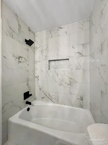 a bathroom with a bathtub and a shower
