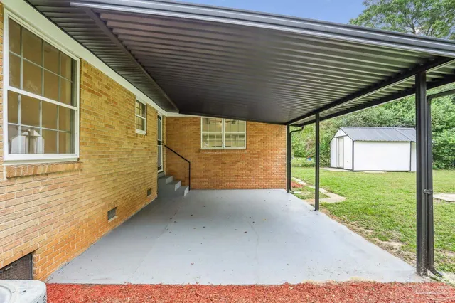 a view of a house with a yard and sitting area