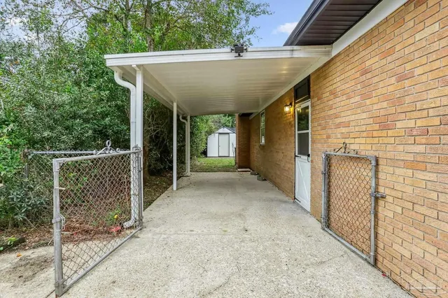 a view of a back yard with a wooden fence
