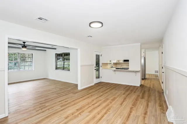 a view of a kitchen with wooden floor
