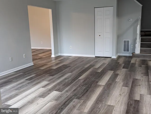 a view of an empty room and wooden floor