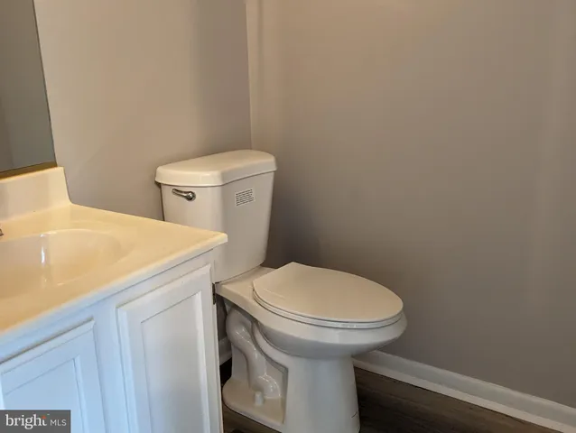 a white toilet sitting next to a white sink