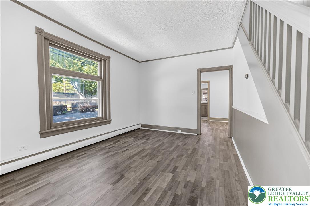 1128 Maple Street Bethlehem, PA 18018 - Photo 29 of 34 A well-lit living area features durable wood-look flooring and a prominent window.