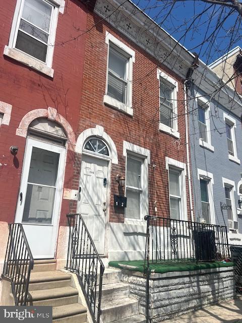 a view of a brick building with many windows