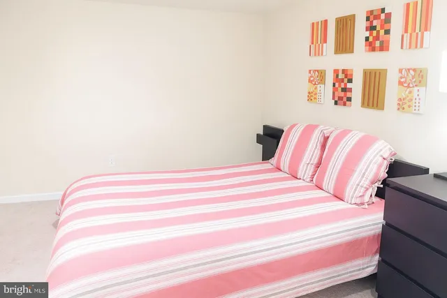 a bedroom with a bed and a book shelf
