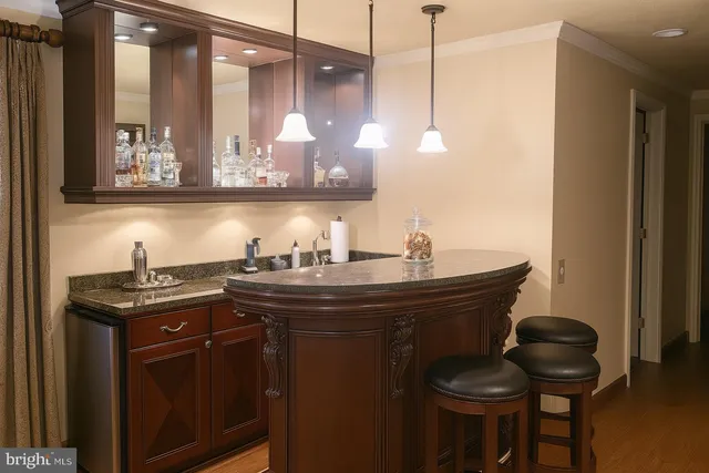 a kitchen with a sink a stove and chairs