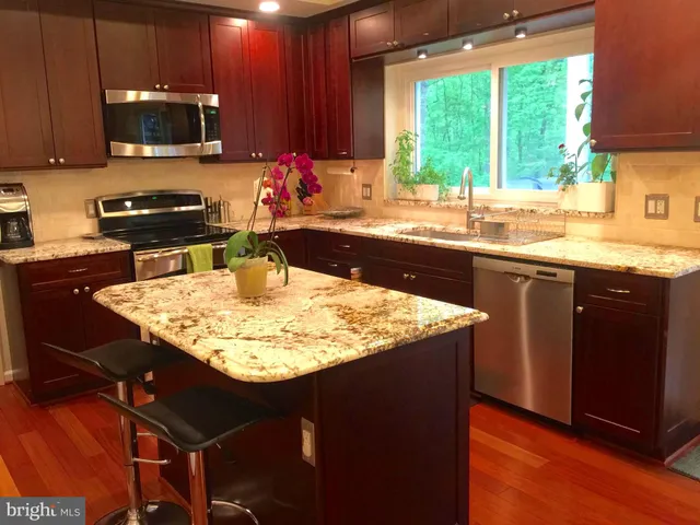 a kitchen with a sink a counter top space and a window