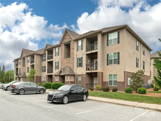 a car parked in front of a white house