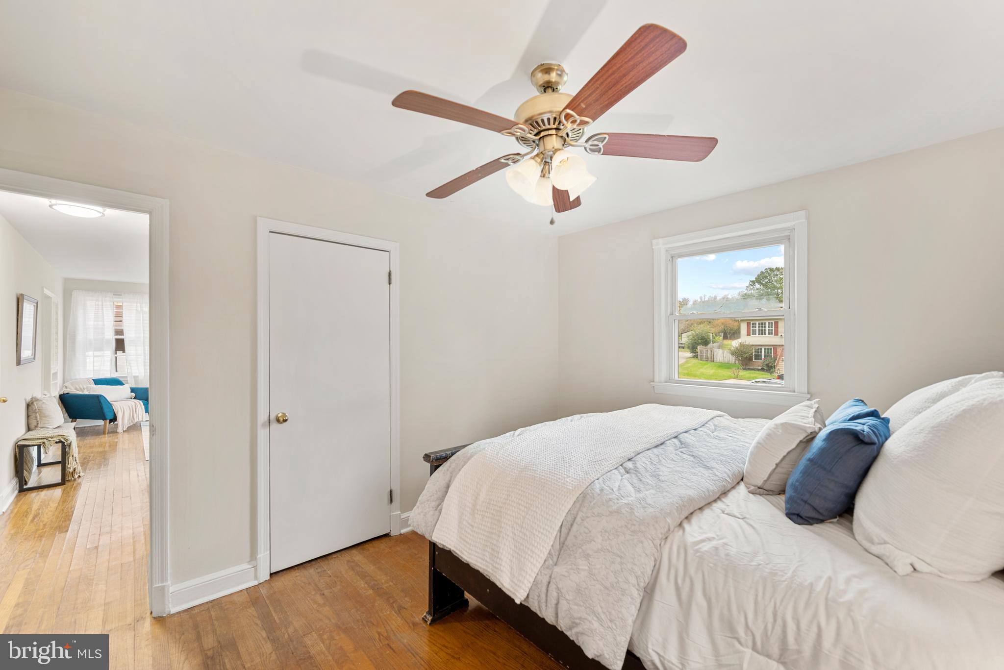 7807 Colonial Lane Clinton, MD 20735 - Photo 13 of 29 a bedroom with a bed and a chandelier