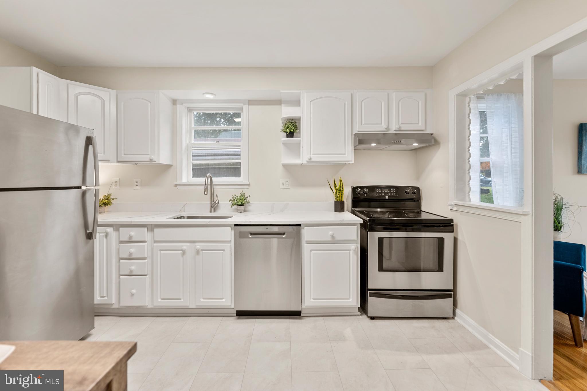 7807 Colonial Lane Clinton, MD 20735 - Photo 4 of 29 a kitchen with white cabinets and white appliances