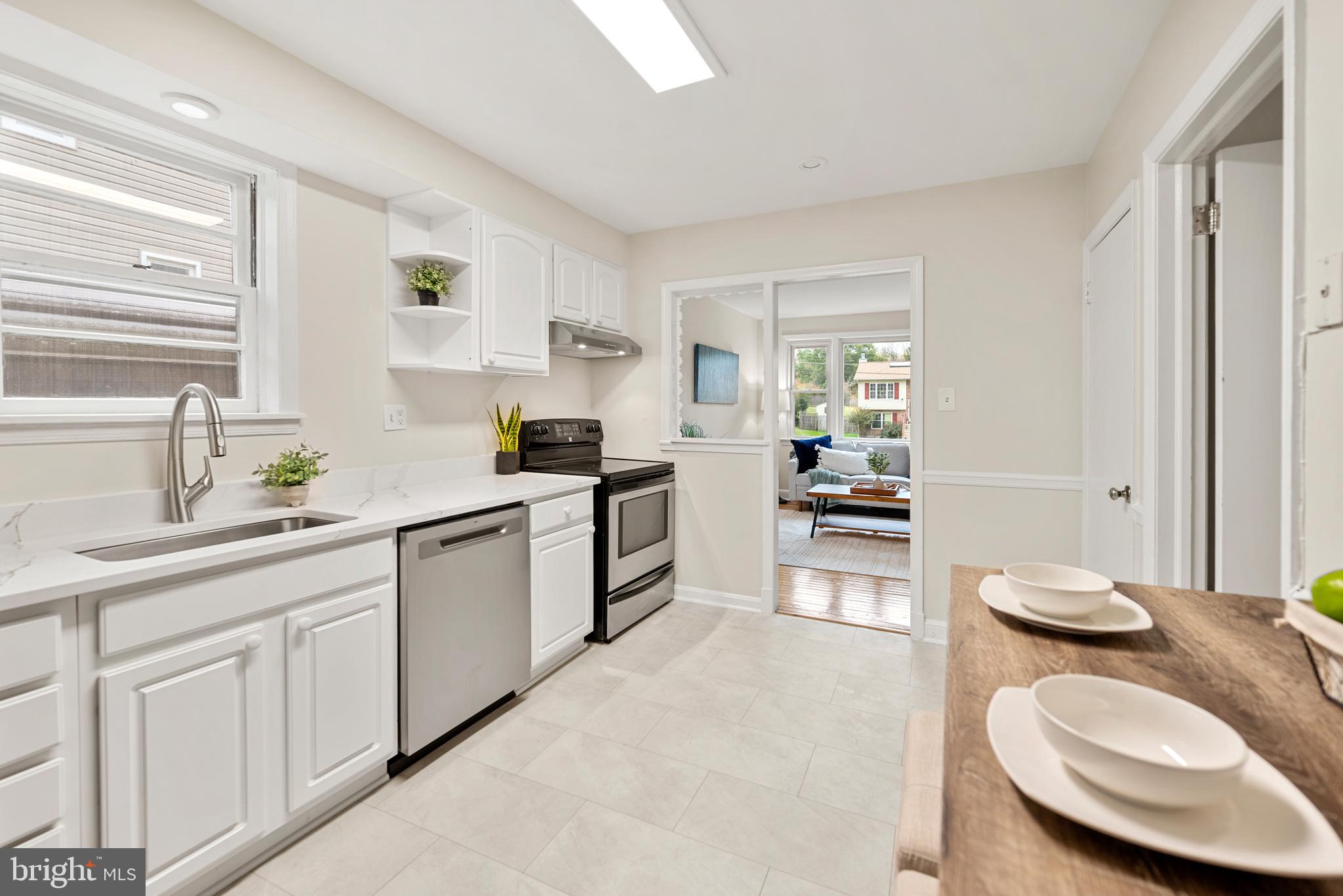 7807 Colonial Lane Clinton, MD 20735 - Photo 6 of 29 a kitchen with a white cabinets and white appliances
