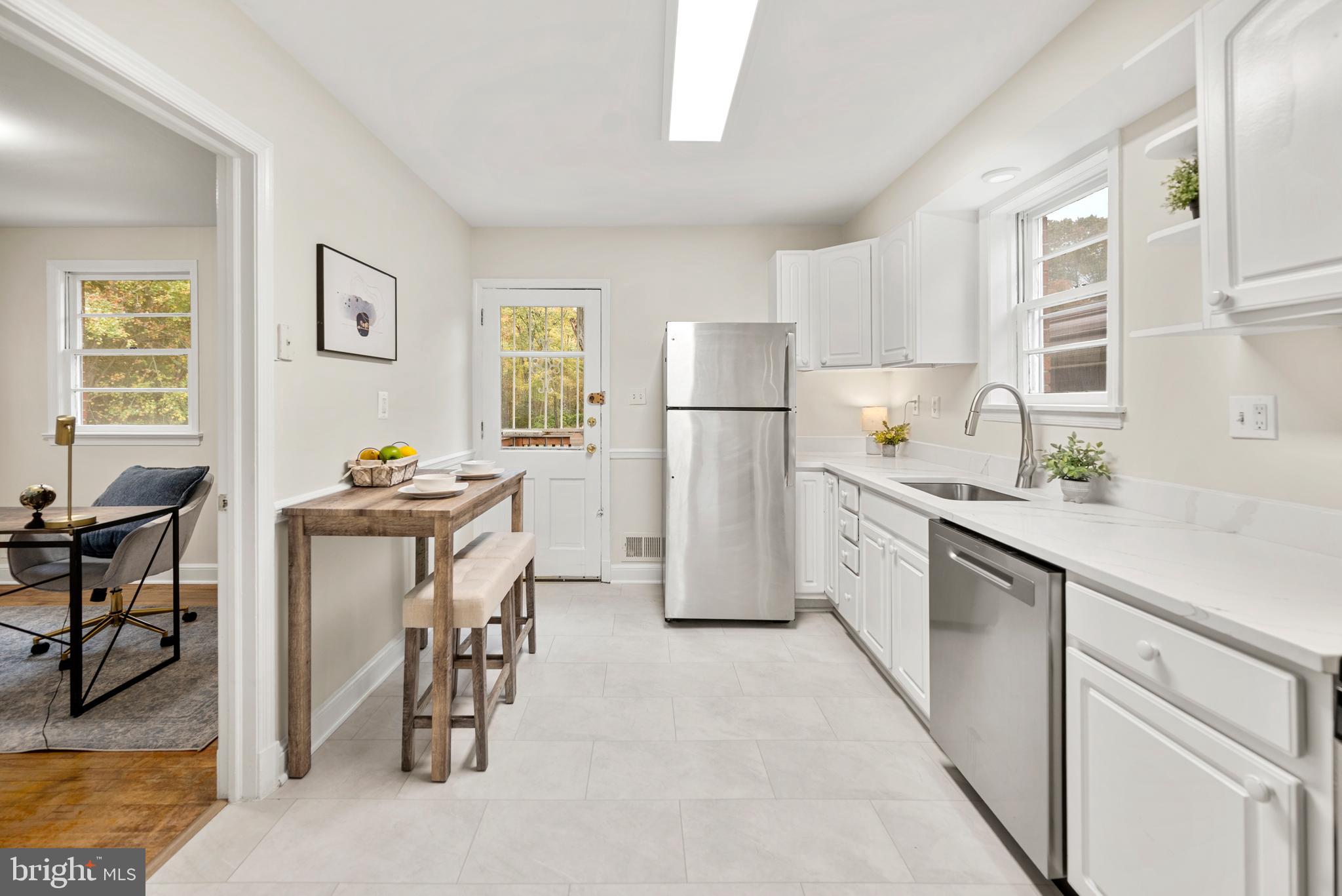 7807 Colonial Lane Clinton, MD 20735 - Photo 7 of 29 a kitchen with white cabinets and chairs