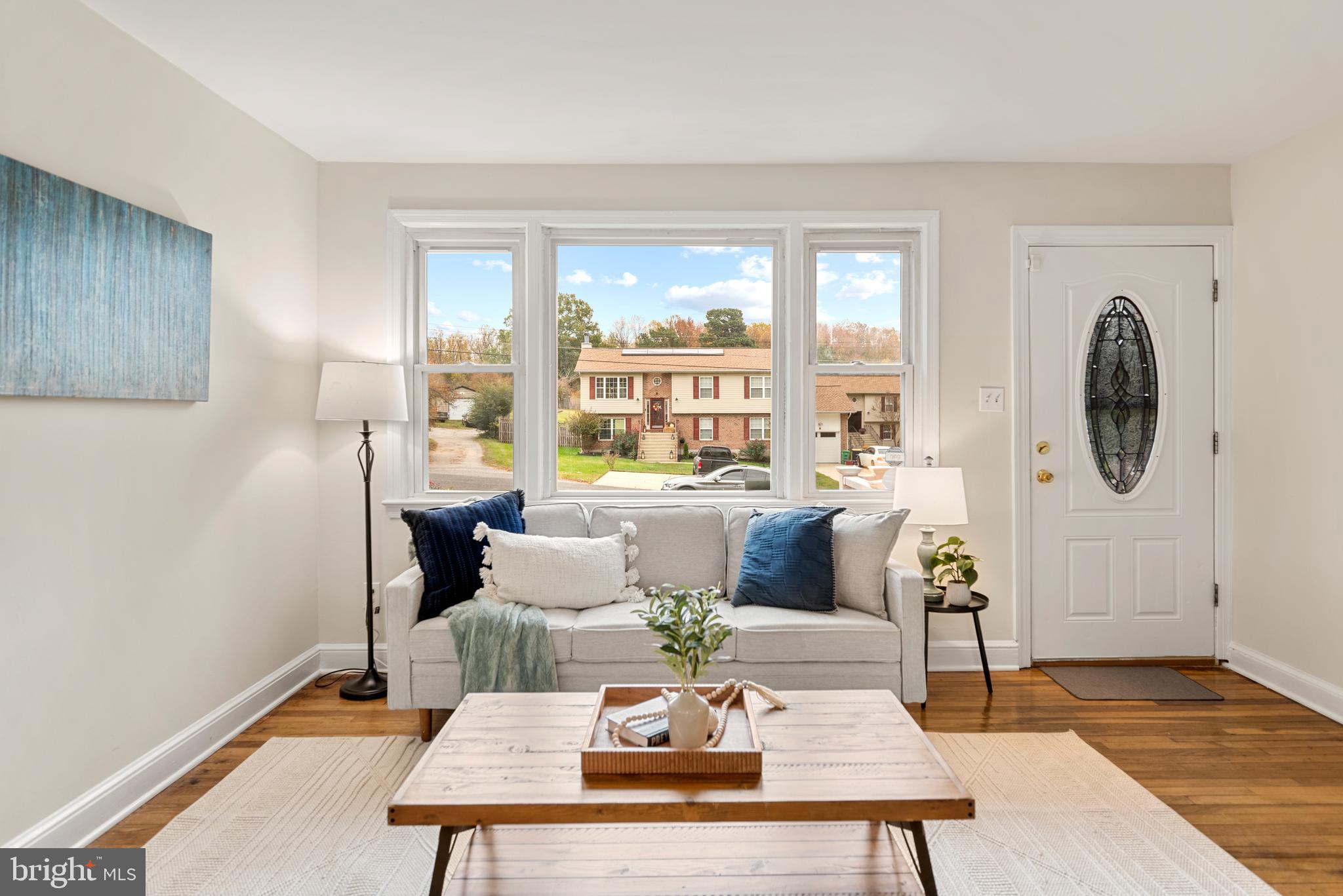 7807 Colonial Lane Clinton, MD 20735 - Photo 9 of 29 a living room with furniture a large window and a table