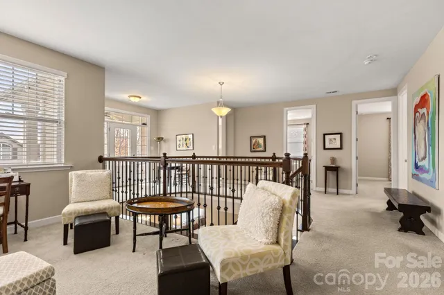 a living room with furniture a window and a flat screen tv